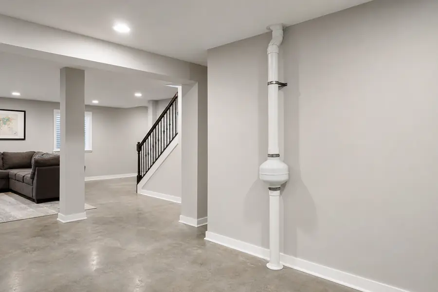 Radon mitigation vent pipe system in a clean Chicago basement
