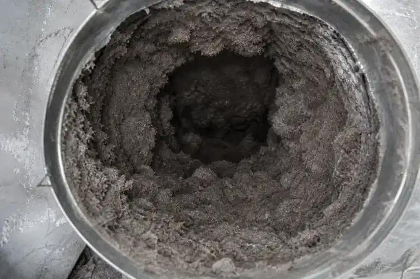 Before: Dryer duct packed with thick lint buildup