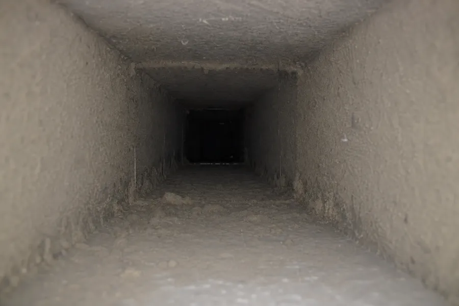 Before: duct interior coated in fine gray drywall dust after a kitchen remodel