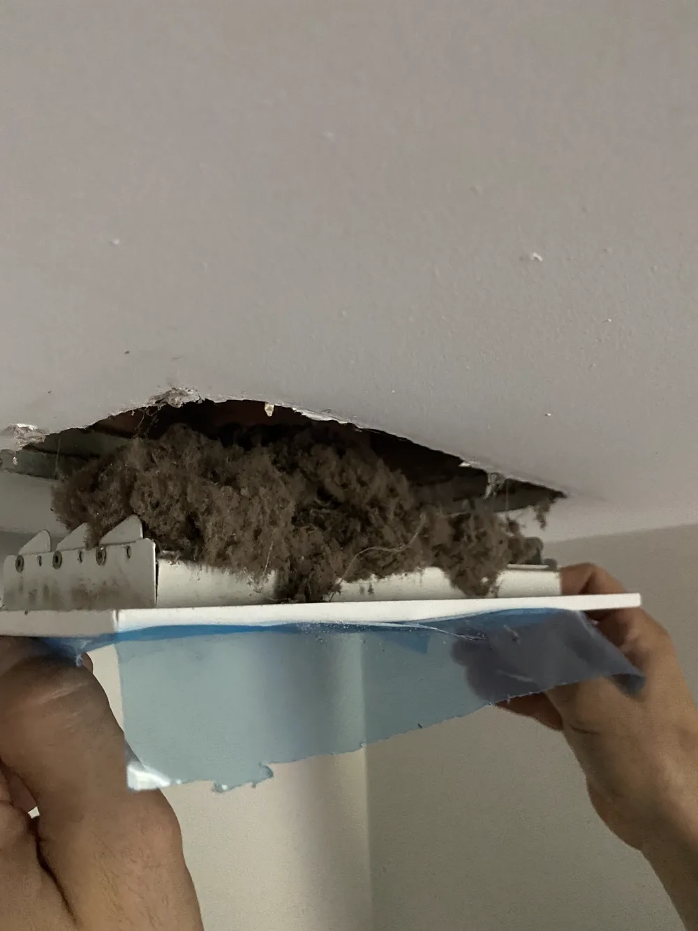 Technician cleaning a residential dryer vent